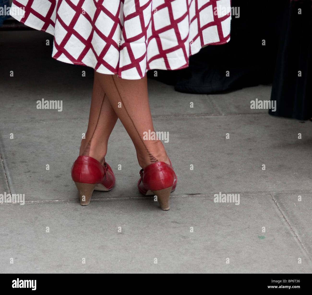 1940`s style women with legs crossed and seamed stockings. Stock Photo